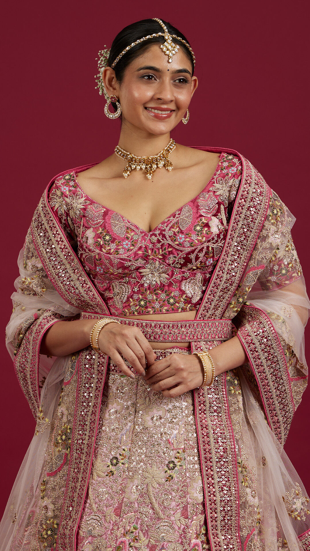A bride flaunting her beautiful pink lehenga and bridal jewellery